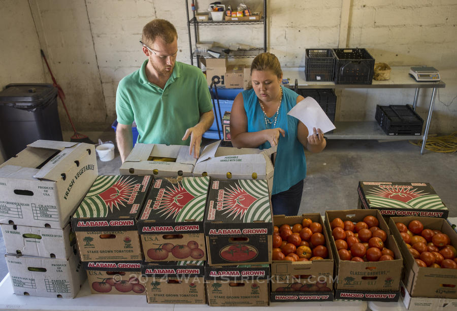 Will Upchurch and Raghela Scavuzzo prepare fresh vegetables and fruit for the weekly distribution to local restaurants and to markets in low income areas of the city of Birmingham.
